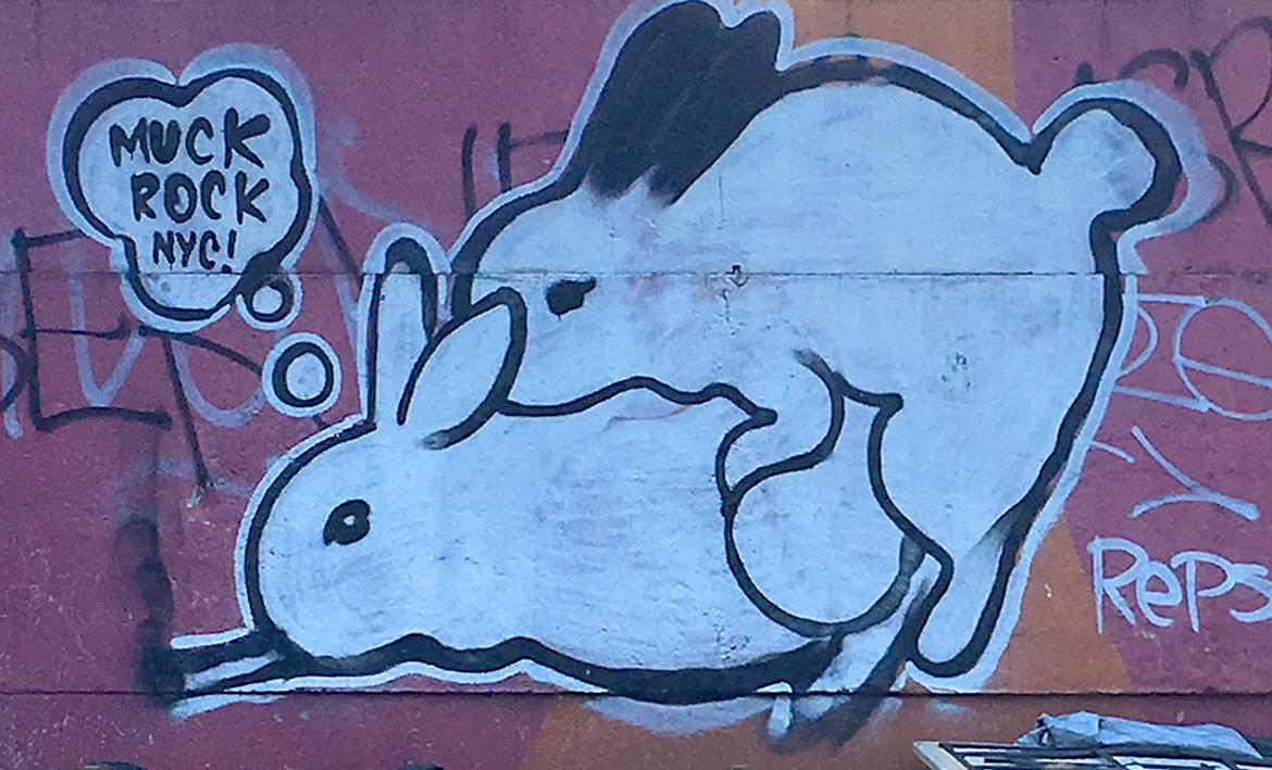 spray paint graffiti of two rabbits having sex