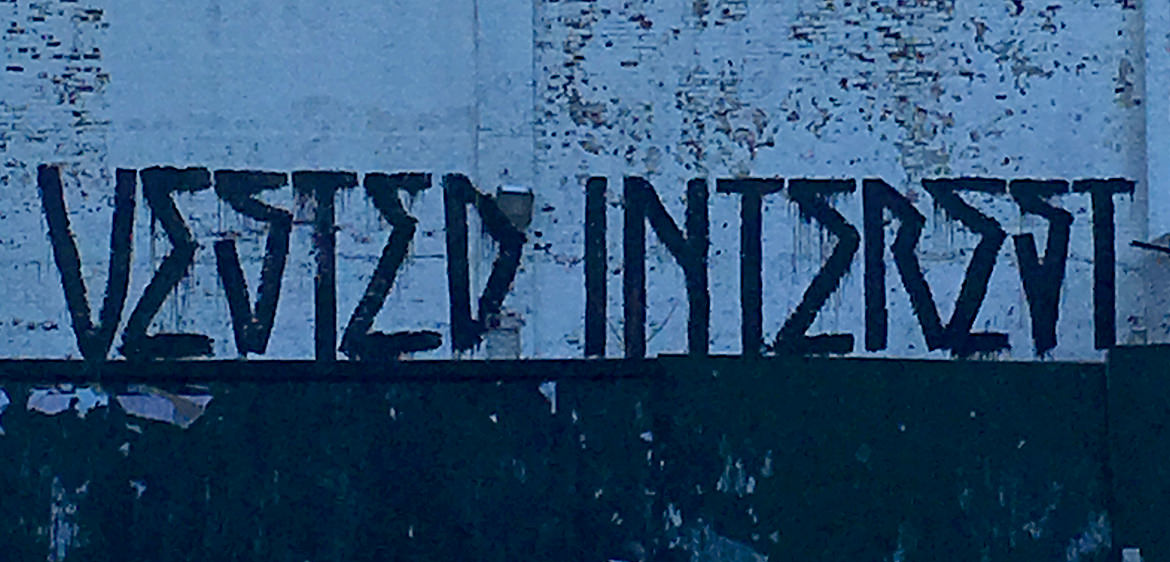 graffiti lettering saying "vested interest"