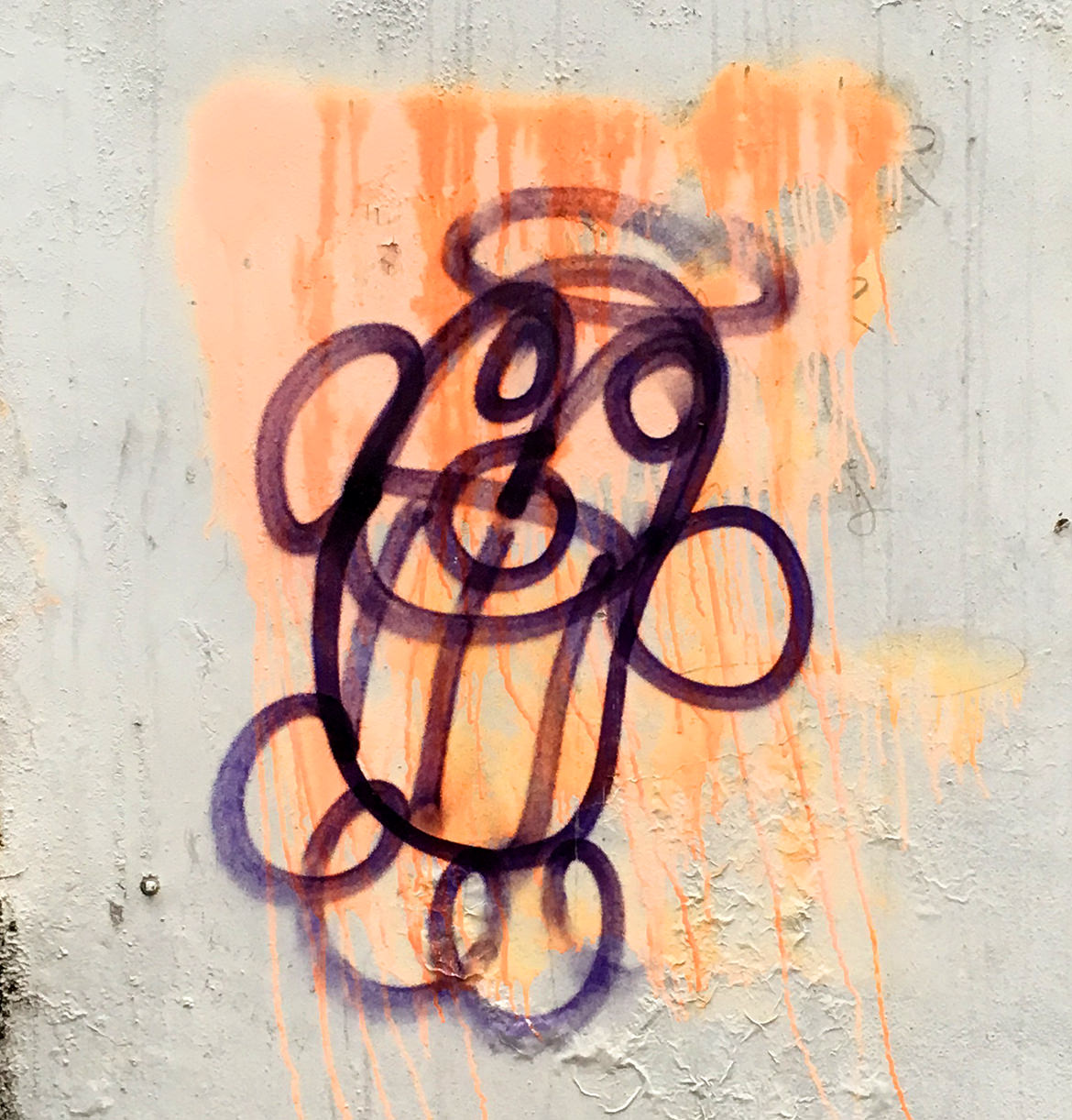 Grafitti of a happy smiling face with a halo above the head