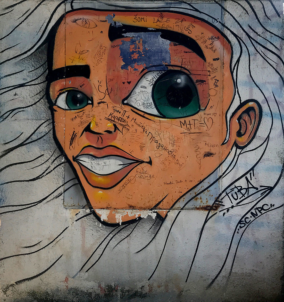A graffiti painting of a woman with one giant eye and white wavy hair
