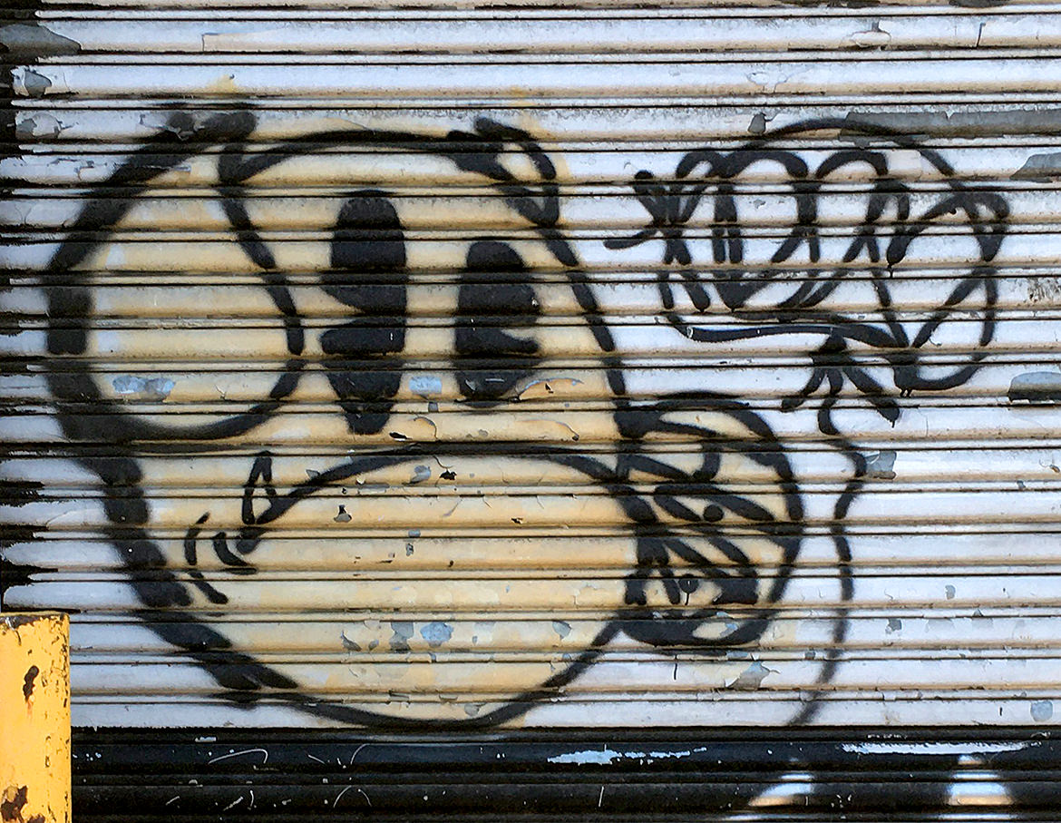 Spray paint graffiti of a grumpy bulldog face