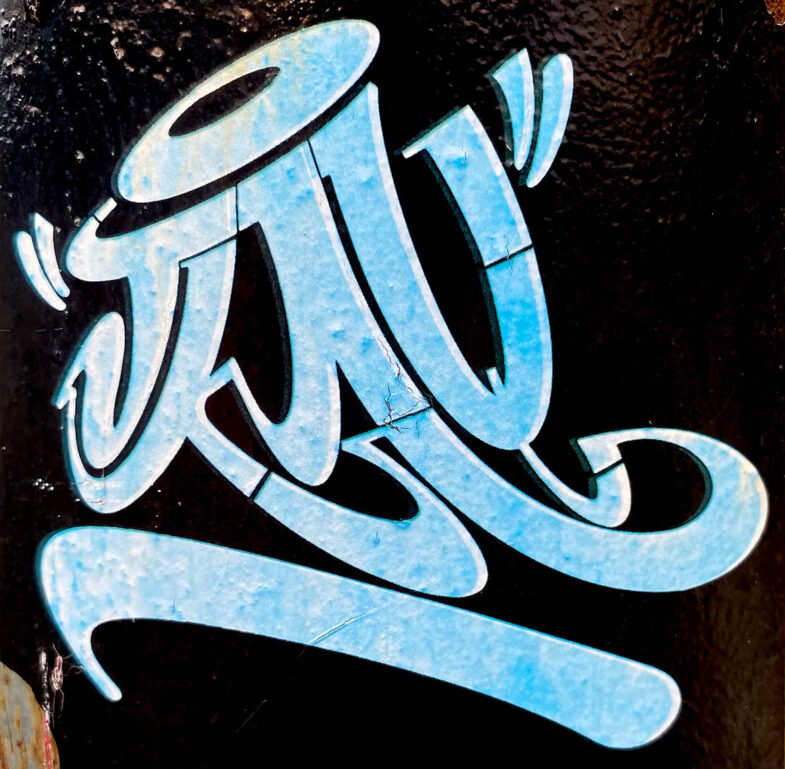 A sticker with light blue script graffiti lettering on a black background