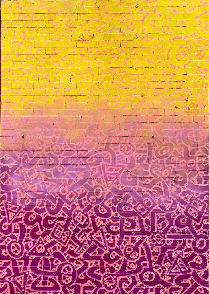 A mural with a background of yellow at the top fading to purple at the bottom and intricate, maze-like interlocking shapes painted within