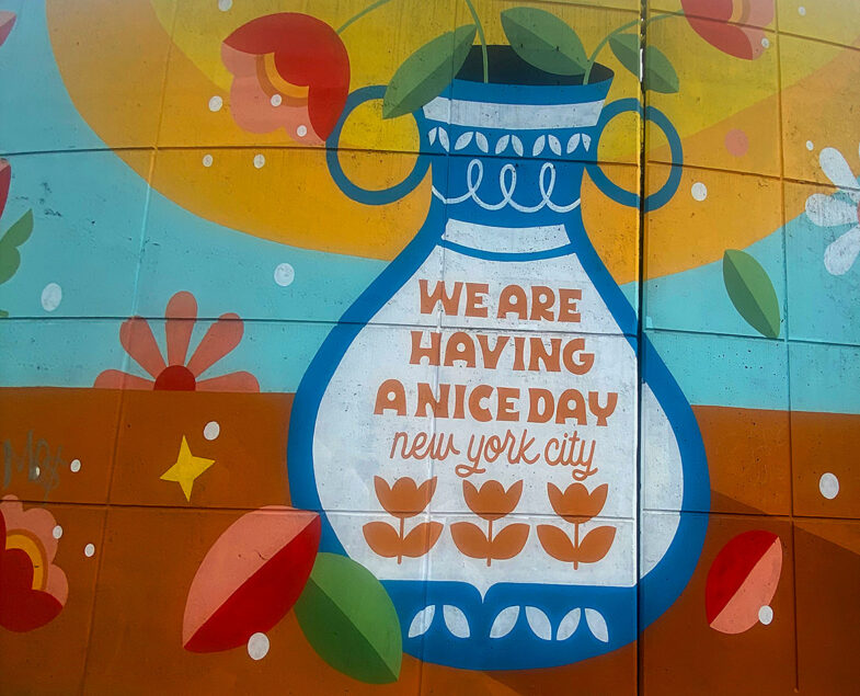 A mural of a blue and white flower vase with the words "We are having a nice day New York City" written within.