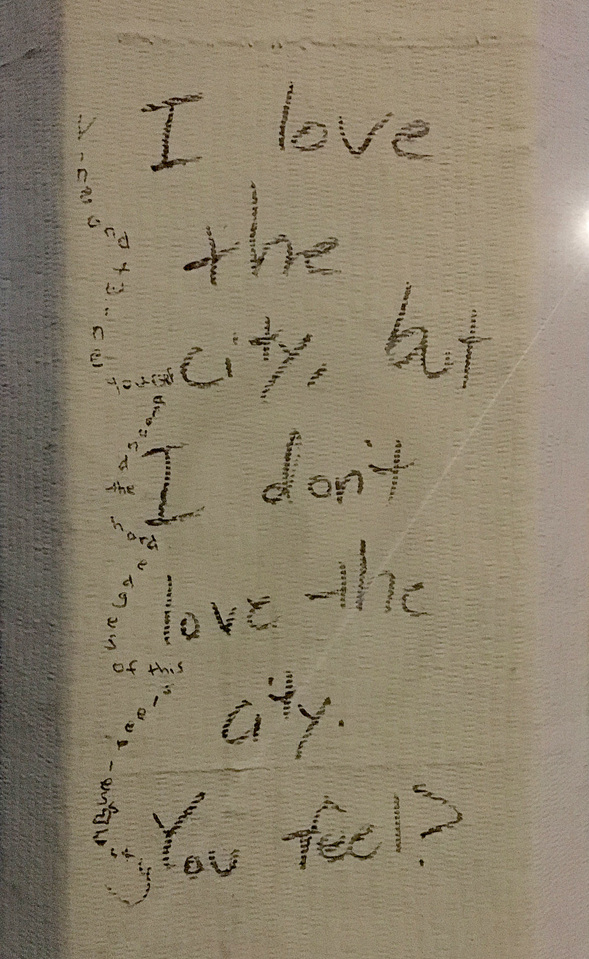 graffiti writing, "i love the city, but I don't love the city, you feel?"