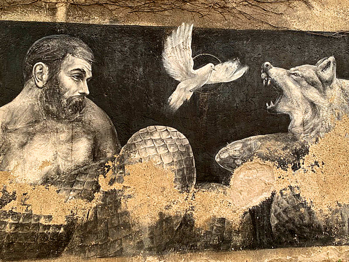 Street mural of a dove flying up between a man and a snarling wolf