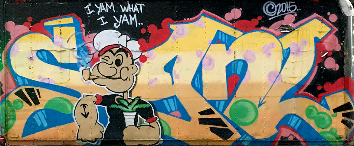 Spray paint graffiti of lettering with the cartoon character Popeye